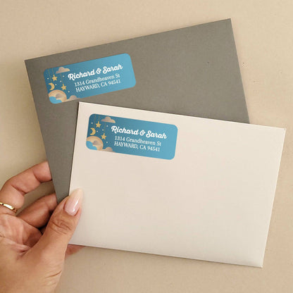 Personalized rectangular return address label with teal blue background, hanging golden stars, crescent moon, and clouds with bold white text - XOXOKristen