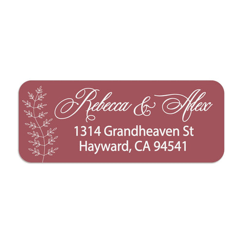 Close-up of burgundy return address sticker with graceful white calligraphy script and botanical branch motif, printed on rectangular label - XOXOKristen