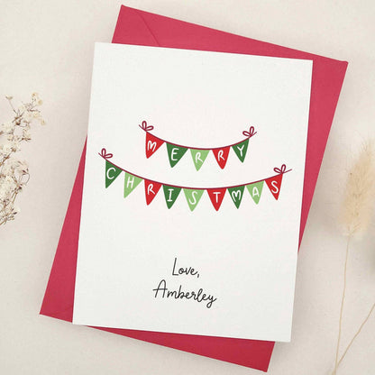 Holiday card with Merry Christmas bunting design, styled with red envelope – XOXOKristen