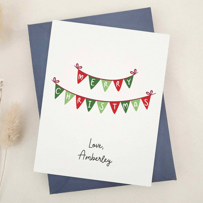 Christmas bunting greeting card spelling Merry Christmas, shown with navy envelope – XOXOKristen