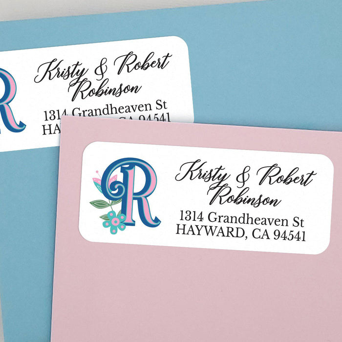 Elegant personalized address label featuring blue and pink decorative letter  with teal leaves and small flowers - XOXOKristen