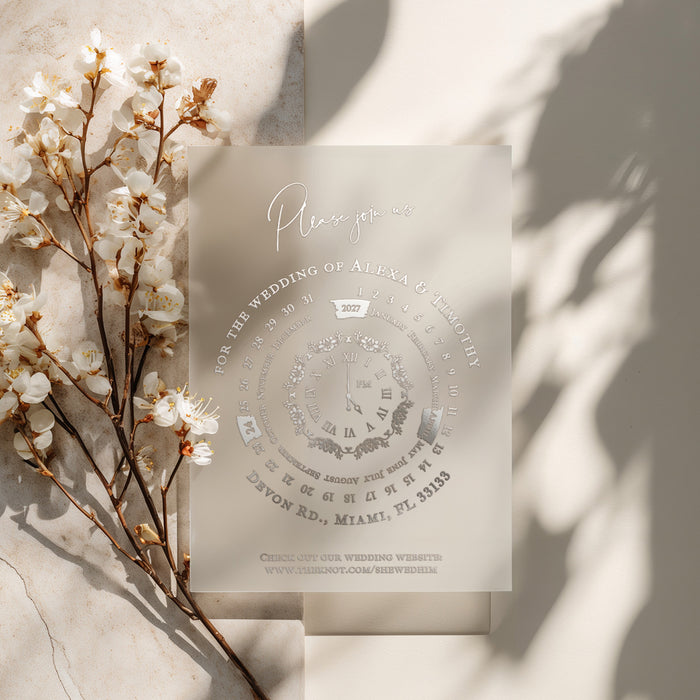 Elegant vellum wedding invitation with silver foil lettering, refined circular layout, and soft floral styling in natural light – XOXOKristen