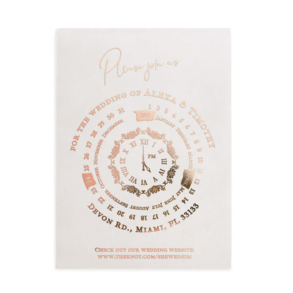 Frosted vellum wedding invitation with rose-gold foil and serif typography, highlighting a circular clock centerpiece – XOXOKristen